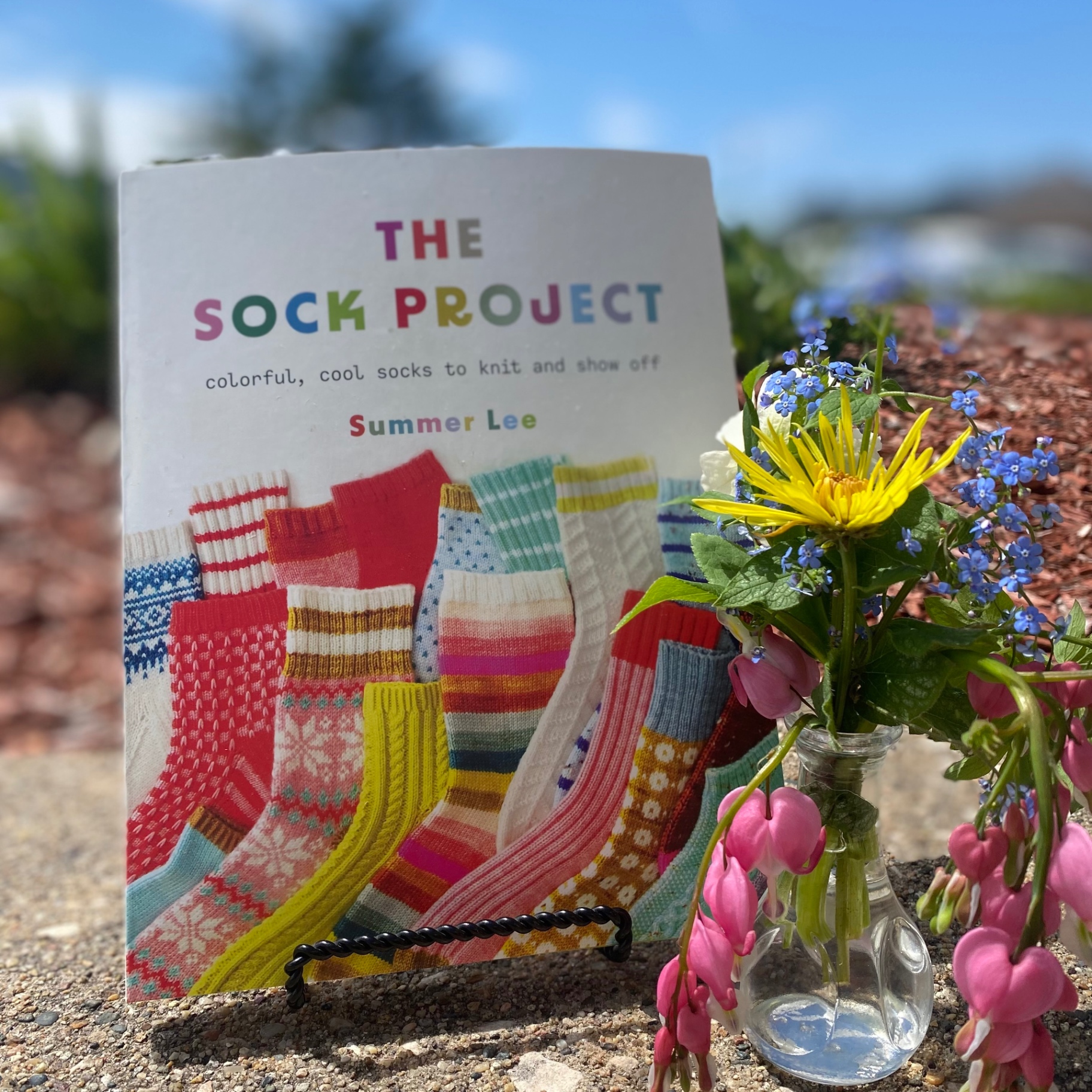 The Sock Project book displayed with spring flowers